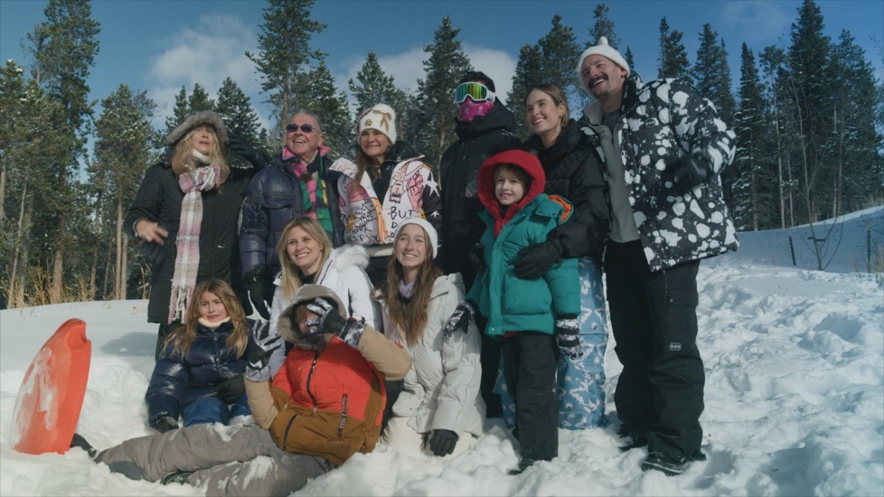 A group of people posing in the snow

Description automatically generated